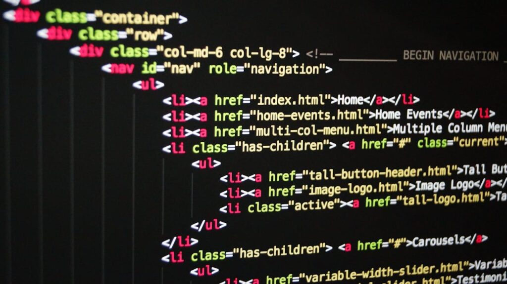 pexels-photo-270404 Close-up of vibrant HTML code displayed on a computer screen, showcasing web development and programming.