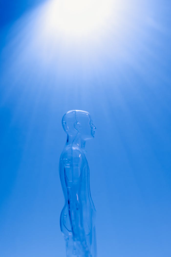 A transparent human figure under a bright blue light creating a futuristic ambiance.